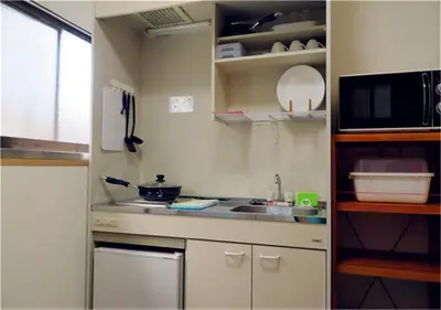 a small kitchen with a sink and a microwave at Kiki HouseT --Self Check-in -- Room Number & Password is in the following email in Tokyo