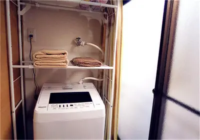 a laundry room with a washing machine and towels at Kiki HouseT --Self Check-in -- Room Number & Password is in the following email in Tokyo