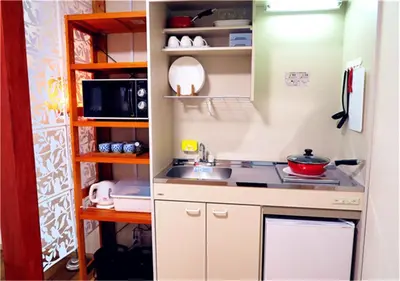 a small kitchen with a sink and a microwave at Kiki HouseT --Self Check-in -- Room Number & Password is in the following email in Tokyo