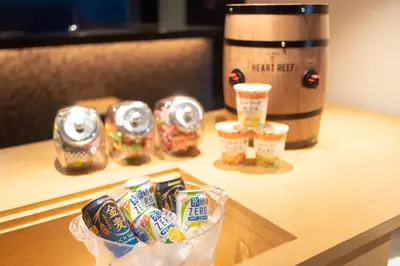 a table with a container of food and a barrel of beer at Hotel New Shohei in Tokyo