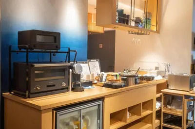 a kitchen with a counter with a microwave and a tv at Hotel New Shohei in Tokyo