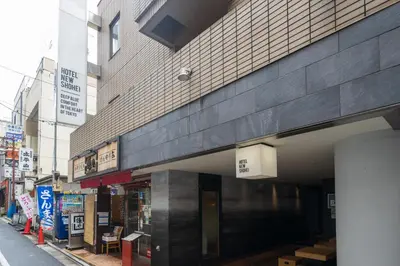 a building on a city street with a store at Hotel New Shohei in Tokyo
