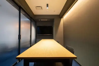 a conference room with a wooden table and chairs at Hotel New Shohei in Tokyo