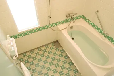 a bathroom with a bath tub and a window at Tokyo Bay Maihama Hotel First Resort in Urayasu
