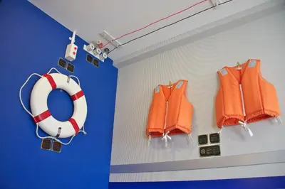 two orange life jackets and a life preserver on a wall at Tokyo Bay Maihama Hotel First Resort in Urayasu