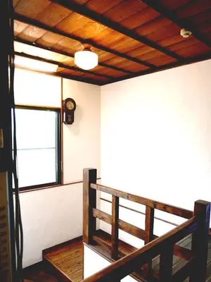 a room with a wooden railing and a window at Ryokan Nakadaya in Tokyo