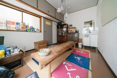 a living room with a bench and a table at Ryokan Nakadaya in Tokyo