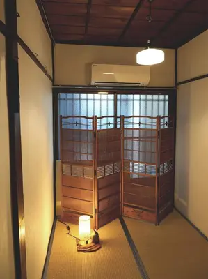 a room with two bunk beds and a light on the floor at Ryokan Nakadaya in Tokyo