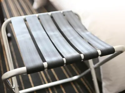 a black chair sitting next to a bench at APA Hotel Tokyo Kudanshita in Tokyo