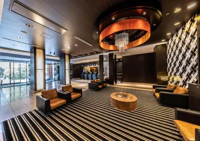 a lobby of a hotel with chairs and a table at APA Hotel & Resort Tokyo Bay Shiomi in Tokyo