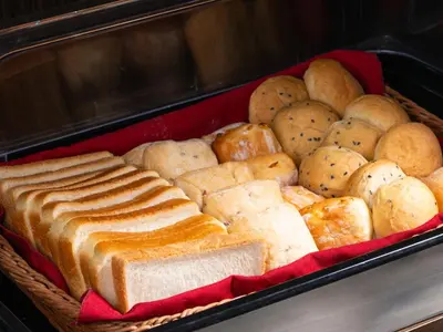 a tray of bread and other baked goods at APA Hotel Asakusa Kuramae in Tokyo