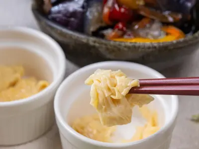 a pair of chopsticks holding food in a bowl at APA Hotel Asakusa Kuramae in Tokyo