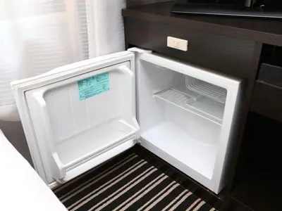 an empty refrigerator with its door open in a kitchen at APA Hotel Tokyo Itabashi Ekimae in Tokyo