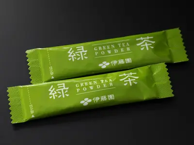 three packets of green tea powder on a black background at APA Hotel Akasaka Mitsuke in Tokyo