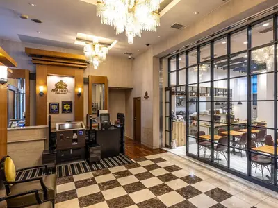 a lobby with a restaurant with a counter and chairs at APA Hotel Nishiazabu in Tokyo