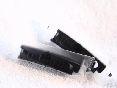 two black toothbrushes sitting on a white surface at APA Hotel Nishiazabu in Tokyo