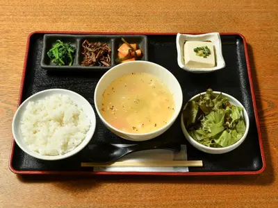 a tray of food with rice and soup and vegetables at APA Hotel Shimbashi Onarimon in Tokyo