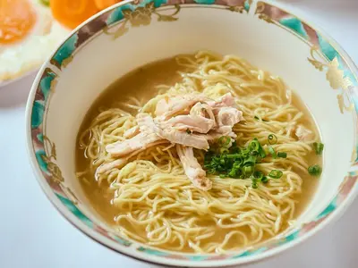 a bowl of chicken noodle soup with meat and green onions at APA Hotel Kodemmacho Ekimae in Tokyo