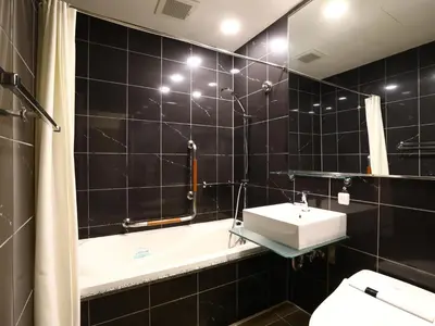 a bathroom with a sink and a bath tub at APA Hotel Kodemmacho Ekimae in Tokyo