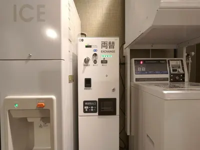 a kitchen with a machine next to a stove at APA Hotel Nihonbashi Hamacho Ekiminami in Tokyo