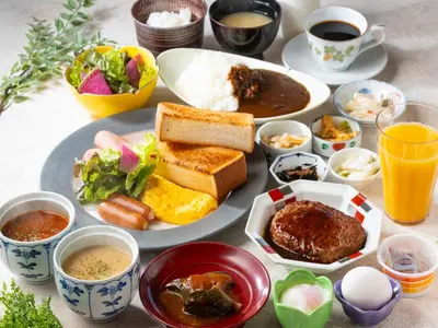a table with a plate of food and bowls of food at APA Hotel Nihonbashi Hamacho Ekiminami in Tokyo