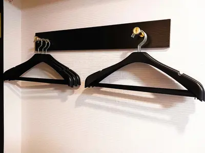 two black hangers are hanging on a wall at APA Hotel Tsukiji Ekiminami in Tokyo