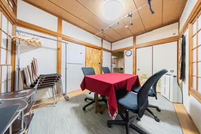 a conference room with a red table and chairs at Ikebukuro no Yado detached house in Tokyo