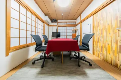 a conference room with a red table and chairs at Ikebukuro no Yado detached house in Tokyo