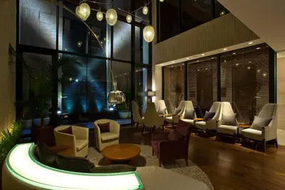 a lobby with a waiting area with chairs and tables at Solaria Nishitetsu Hotel Ginza in Tokyo