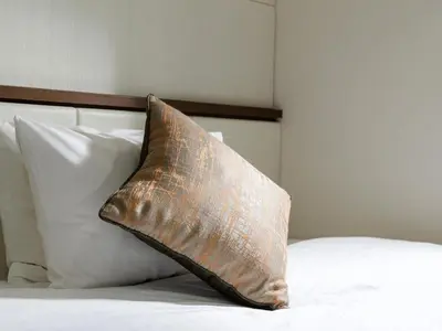 a pillow sitting on top of a bed at Solaria Nishitetsu Hotel Ginza in Tokyo