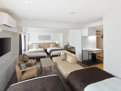 a hotel room with two beds and a living room at HOTEL MYSTAYS Kiyosumi Shirakawa in Tokyo