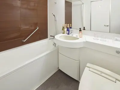 a white bathroom with a sink and a bath tub at HOTEL MYSTAYS Kiyosumi Shirakawa in Tokyo