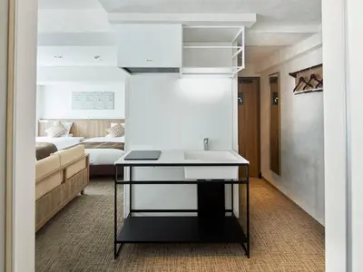 a kitchen with a sink and a room with a bed at HOTEL MYSTAYS Kiyosumi Shirakawa in Tokyo