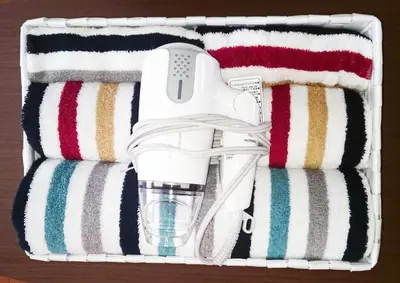 a white hairdryer in a box with striped towels at Namio Apartment 201 in Tokyo