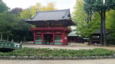 a red building with a roof in a park at Namio Apartment 201 in Tokyo