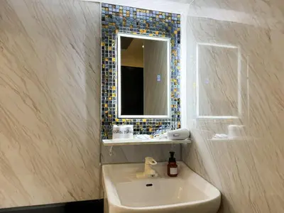 a bathroom with a sink and a mirror at Hotel Amethyst in Tokyo