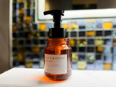 a bottle of face and hand soap sitting on a table at Hotel Amethyst in Tokyo