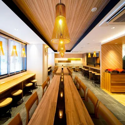 a restaurant with long wooden tables and chairs at Super Hotel Tokyo Shiba in Tokyo