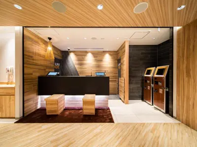 a dressing room with wooden walls and wooden floors at Super Hotel Tokyo Shiba in Tokyo