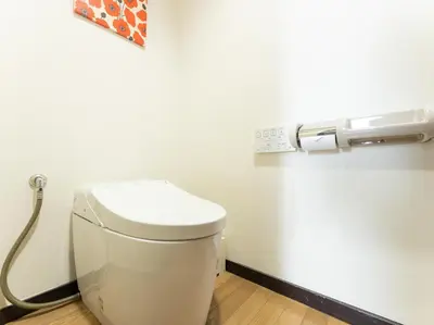 a white toilet in a bathroom with a toilet paper dispenser at Tabist Urban Stays Asakusa in Tokyo