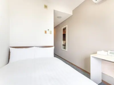 a small bedroom with a bed and a desk at Tabist Urban Stays Asakusa in Tokyo