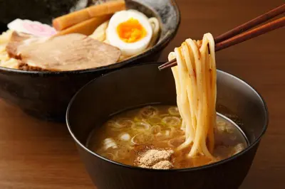 two bowls of soup with noodles and eggs on a table at Tabist Urban Stays Asakusa in Tokyo