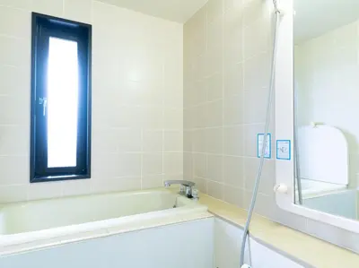 a bathroom with a bath tub and a window at Tabist Urban Stays Asakusa in Tokyo
