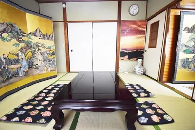 a room with a table and a painting on the wall at Oasis Minamiyukigaya in Tokyo