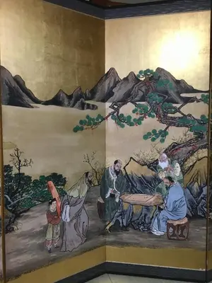a painting of a group of people on a wall at Oasis Minamiyukigaya in Tokyo