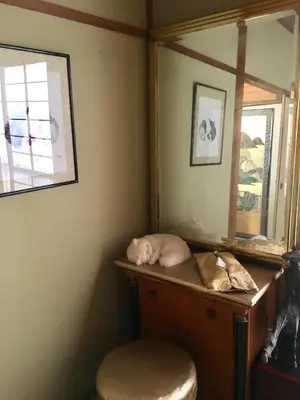 a dressing table with a mirror and a stool at Oasis Minamiyukigaya in Tokyo