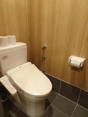 a bathroom with a toilet and a roll of toilet paper at Capsule Inn Kinshicho in Tokyo