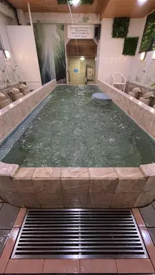 a large pool of water in a large room at Capsule Inn Kinshicho in Tokyo
