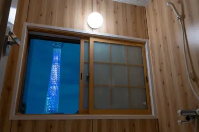 a bathroom window with the eiffel tower visible at Playsis East Tokyo in Tokyo
