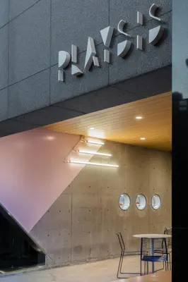 a table and chairs in front of a building at Playsis East Tokyo in Tokyo
